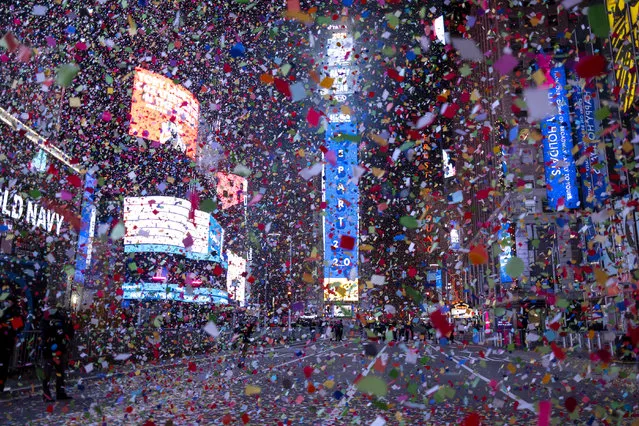 The Times Square New Year's Eve Ball drops as confetti flies in an empty Times Square, early Friday, January 1, 2021, as the area normally packed with revelers remained closed off due to the ongoing coronavirus pandemic. (Photo by Craig Ruttle/AP Photo)