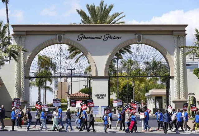 Striking writers rally in front of the entrance to the Paramount Pictures studio, Tuesday, May 2, 2023, in Los Angeles. Television and movie writers launched a strike for the first time in 15 years, as Hollywood girded for a walkout with potentially widespread ramifications in a fight over fair pay in the streaming era. (Photo by Chris Pizzello/AP Photo)