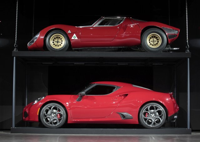 A 2015 Alfa Romeo 4C (bottom) is displayed along with a 1967 Alfa Romeo 33 Stradale (top) during the first press preview day of the North American International Auto Show in Detroit, Michigan January 12, 2015. (Photo by Rebecca Cook/Reuters)