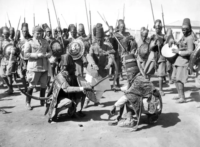 Rhythmic two-step by two Askari Chiefs during a ceremonial war dance held by Askaris – native troops employed by the Italians – to celebrate victory on December 16, 1935. An Italian officer is seen looking on. (Photo by AP Photo)