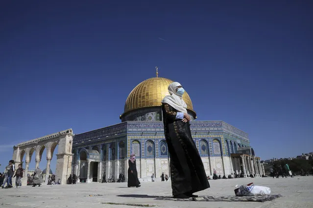 A Muslim woman takes part in Friday prayers at the Dome of the Rock Mosque in the Al Aqsa Mosque complex in the Old City of Jerusalem, which has reopened to visitors following a third lockdown to curb the spread of the coronavirus, Friday, February 12, 2021. (Photo by Mahmoud Illean/AP Photo)