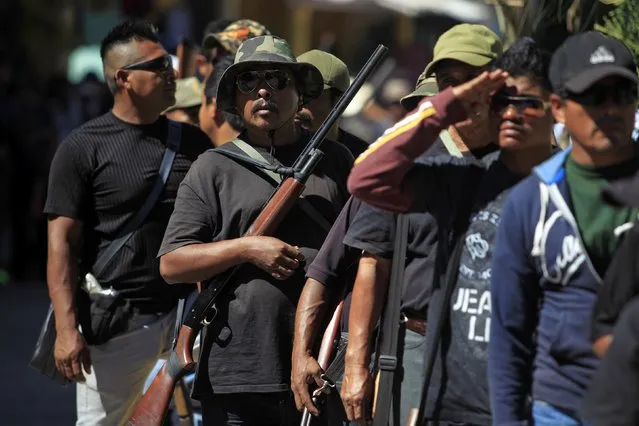 Members of the Community Police of the FUSDEG (United Front for the Security and Development of the State of Guerrero) take part in a march to mark the first anniversary of the force's operations in Ocotito, January 23, 2015. (Photo by Jorge Dan Lopez/Reuters)