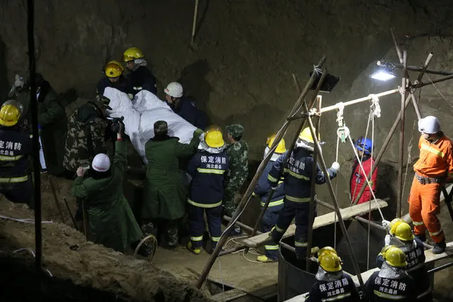 Rescuers carry out the dead body of the boy who fell into a 40-metre-deep well on November 6, in Baoding, Hebei province, China November 10, 2016. (Photo by Reuters/China Daily)