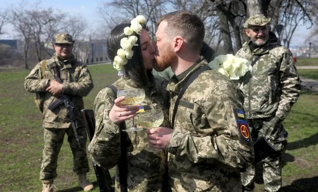 Members of the Ukrainian Territorial Defence Forces Anastasiia (24) and Viacheslav (43) attend their wedding ceremony, amid Russia's invasion of Ukraine, in Kyiv, Ukraine, April 7, 2022. (Photo by Mykola Tymchenko/Reuters)