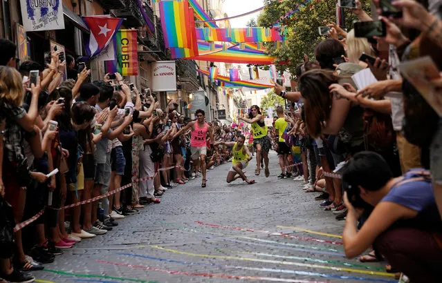 Contestants take part in the annual race on high heels during gay pride celebrations in the quarter of Chueca in Madrid, Spain, July 5, 2018. (Photo by Juan Medina/Reuters)