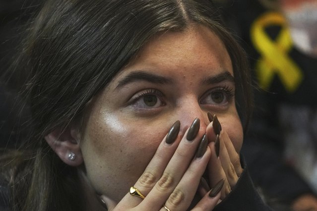 A friend of Sagui Dekel Chen reacts as she watches a live broadcast of his release from Hamas captivity in Giv'ot Bar, southern Israel, Saturday, February 15, 2025. (Photo by Maya Alleruzzo/AP Photo)