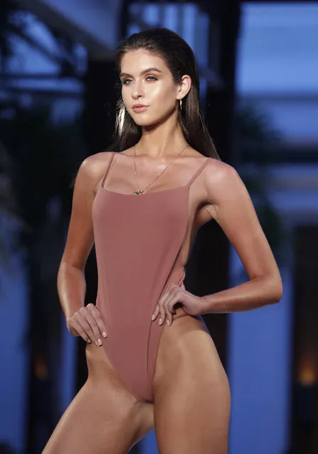A model walks down the runway during the Fashion Palette Miami Australian Swim Show during Miami Swim Week, Sunday, July 15, 2018, in Miami Beach, Fla. (Photo by Lynne Sladky/AP Photo)