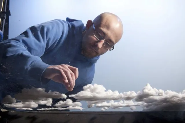 Matthew makes cotton clouds for his model, “Paradise”. (Photo by Matthew Albanese/Barcroft Media)