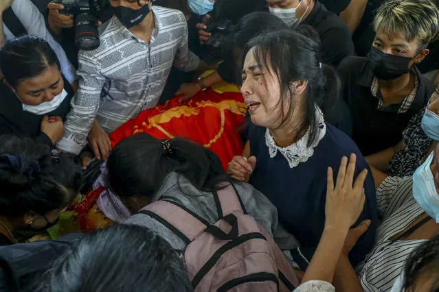 Mother of Khant Ngar Hein weeps during his funeral in Yangon, Myanmar Tuesday, March 16, 2021. Khant Ngar Hein, a 18-year old student of medicine was shot on his chest on Sunday, March 14, in Tamwe, Yangon, by security forces during an anti-crop protest. (Photo by AP Photo/Stringer)