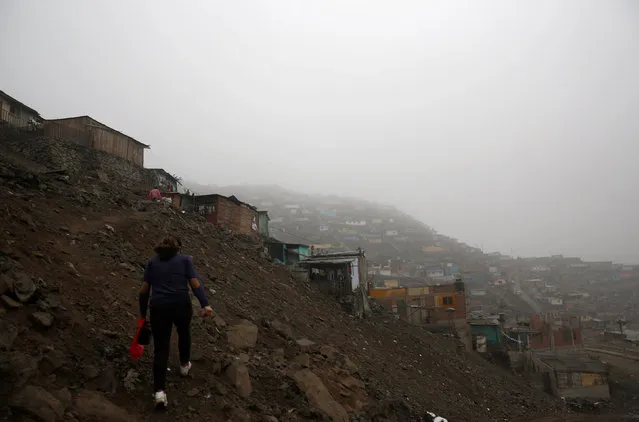 Margarita Valle, a health worker with organisation Partners in Health walks towards the home of a patient who has tuberculosis that her organization supports, in the neighborhoods of Carabayllo in Lima, Peru July 14, 2016. At least 30,000 Peruvians are infected with tuberculosis, an ancient disease that killed 1.8 million globally last year, more than AIDS-related and malaria deaths combined. Partners in Health, a Boston-based non-profit that works with Peru's health ministry, offers a simple solution. It trains community volunteers to tend to tuberculosis sufferers in their homes – ensuring patients take medicine daily and helping them navigate the public health bureaucracy. (Photo by Mariana Bazo/Reuters)