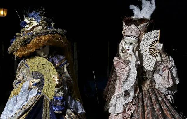Masked revellers pose in front of St. Mark's Square during the Venice Carnival, February 7, 2015. (Photo by Stefano Rellandini/Reuters)