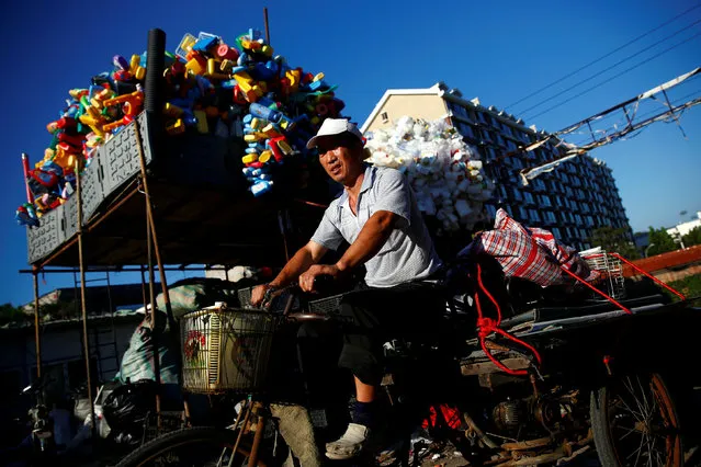 A scrap collector delivers recyclables on a tricycle to a recycling yard at the edge of Beijing, China, August 19, 2016. (Photo by Thomas Peter/Reuters)
