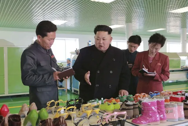 North Korean leader Kim Jong Un (C) gives field guidance during his visit to the Wonsan Shoes Factory in this undated photo released by North Korea's Korean Central News Agency (KCNA) in Pyongyang January 31, 2015. (Photo by Reuters/KCNA)