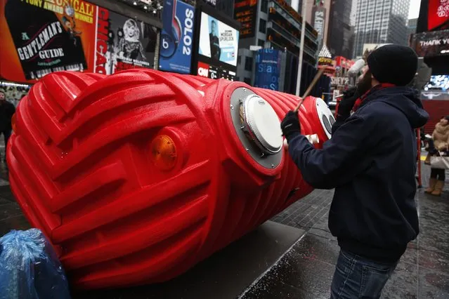 Drummers perform on “HeartBeat” by Stereotank, a Brooklyn-based design studio, which is the 2015 winning Times Square Valentine Heart produced by the Times Square Alliance, in New York City February 9, 2015. The interactive sculpture consisting of a massive heart that visitors are encouraged to move around and play various percussion instruments on, is installed at Times Square and open to the public until March 8. (Photo by Mike Segar/Reuters)