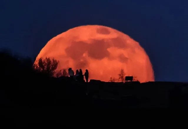 The snow moon rises behind a hill in Wakefield, West Yorkshire on Saturday, February 27, 2021. (Photo by Danny Lawson/PA Images via Getty Images)
