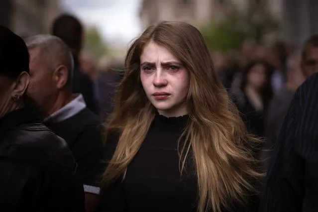 A woman cries during the funerals of Melnyk Andriy, Shufryn Andriy and Ankratov Oleksandra, three Ukrainian military servicemen who were killed in the east of the country, in Lviv, Ukraine, Saturday, May 14, 2022. (Photo by Emilio Morenatti/AP Photo)
