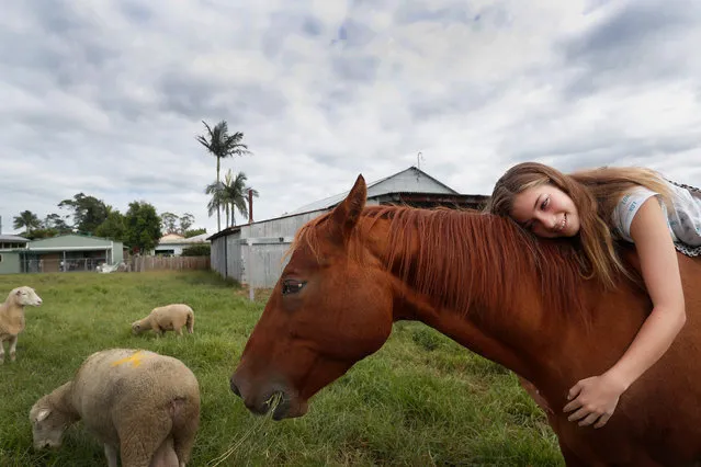 Mia Harris hugs her horse Sharny who survived the recent flooding that inundated her family home in the small township of Croki on March 29, 2021 in Taree, Australia. The Australian Defence force are deploying 611 personnel across New South Wales as part of Operation NSW Flood Assist. Following initial emergency response from HMAS Albatross and RAAF Base Richmond, and Holsworthy, including Navy helicopter support for Search and Rescue. The Australian Defence force is now assisting with recovery operations that significantly increased on March 26th as flood waters started to recede and the operation shifted to a recovery and clean up phase. Unprecedented and devastating flooding across the state in recent weeks has seen tens of thousands of people forced to evacuate after days of torrential rain caused some of the worst floodings the state has ever seen. (Photo by Lisa Maree Williams/Getty Images)