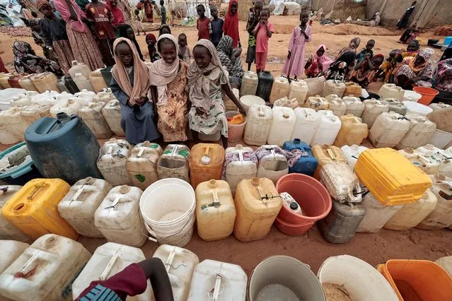 Sudanese girls who fled the conflict in Geneina, in Sudan's Darfur region, line up at the water point in  Adre, Chad on July 30, 2023. (Photo by Zohra Bensemra/Reuters)