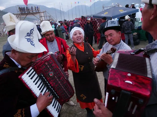 Nazira Ivanova rehearses with her bandmates before taking the stage at an event for traditional music. The song, which stopped several passersby in their tracks, was “about love”, she told RFE/RL. (Photo by Amos Chapple/Radio Free Europe/Radio Liberty)