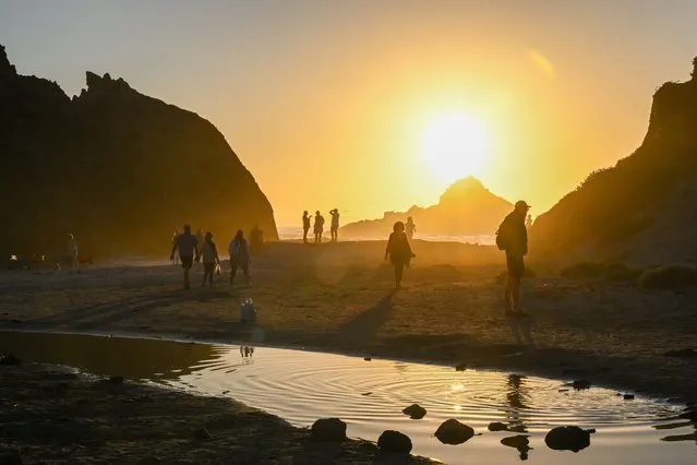Sun sets at the Pfeiffer Beach as people enjoy in Big Sur of California, United States on August 12, 2023. (Photo by Tayfun Coskun/Anadolu Agency via Getty Images)