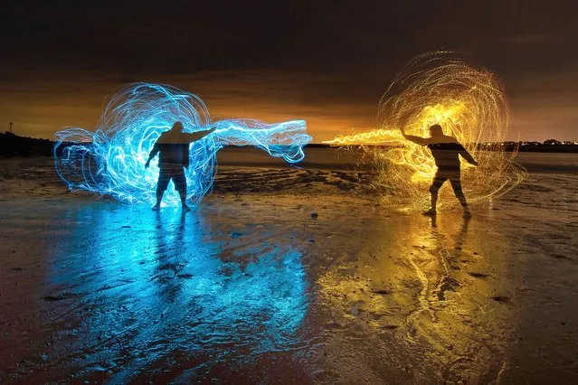 Nigel Cox and Kevin Jay paint with light using fibre optic whips on the beach at Clacton-on-Sea in Essex, United Kingdom on July 25, 2023 with a superhero fighting theme. (Photo by Kevin Jay/Picture Exclusive)