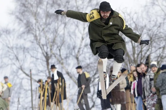 A participant jumps on vintage skis during a traditional historical ski race in the northern Bohemian town of Smrzovka February 21, 2015. (Photo by David W. Cerny/Reuters)