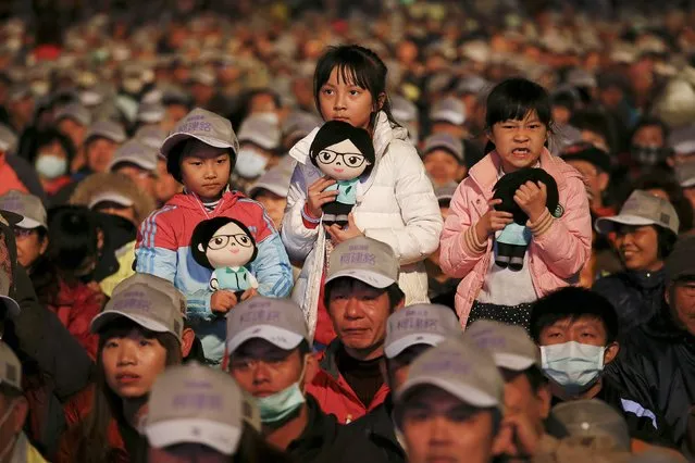 Girls hold dolls featuring Taiwan's Democratic Progressive Party (DPP) Chairperson and presidential candidate Tsai Ing-wen before she addresses supporters during a campaigning rally in Hsinchu ,Taiwan January 14, 2016. (Photo by Damir Sagolj/Reuters)