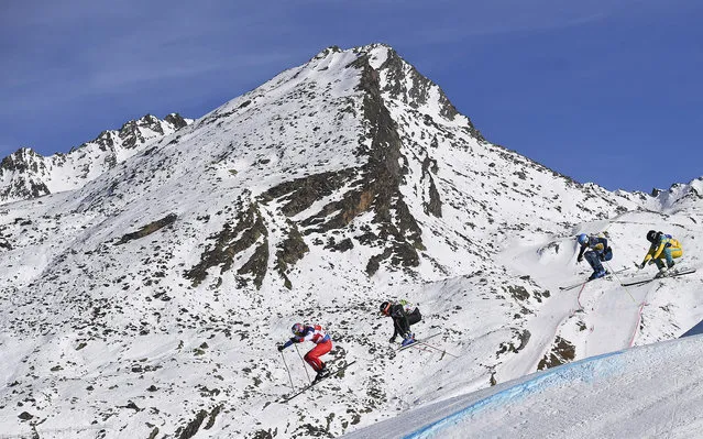 (From L) Switzerland's Alex Fiva, France's Jonathan Midol, Austria's Anton Grimus and Russia's Semen Denshchikov compete during the FIS Men's 1/8 final Skicross World Cup on December 9, 2016 at the Val-Thorens ski resort in the French Alps. (Photo by Franck Fife/AFP Photo)