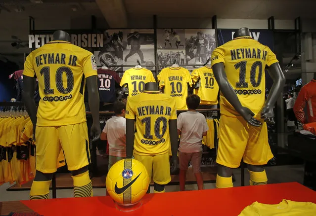 PSG soccer shirts bearing the name of Brazilian soccer star Neymar are placed on display in the Paris Saint Germain store in Paris Friday, August 4, 2017. Neymar was set to arrive in Paris on Friday the day after he became the most expensive player in soccer history when completing his blockbuster transfer to Paris Saint-Germain from Barcelona for 222 million euros ($262 million).(Photo by Michel Euler/AP Photo)