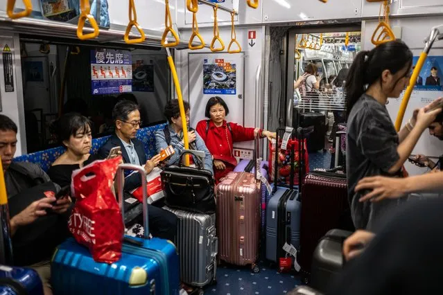 Tourists travel on a subway train to Tokyo's town centre from Narita International Airport in Narita, Chiba Prefecture, outside Tokyo on September 7, 2023. (Photo by Philip Fong/AFP Photo)