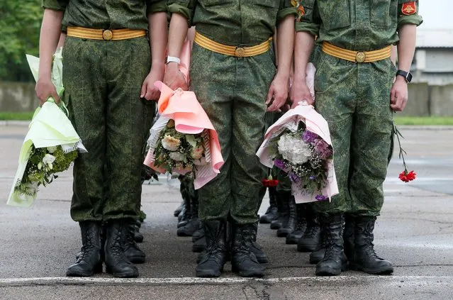 Cadets of a military academy hold flowers during a graduation ceremony in the rebel-controlled city of Donetsk, Ukraine on June 17, 2021. (Photo by Alexander Ermochenko/Reuters)