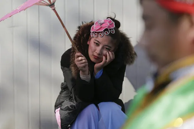 Performers wait for their turn to go onto the stage at the Longtan park as the Chinese Lunar New Year, which welcomes the Year of the Monkey, is celebrated in Beijing, China February 9, 2016. (Photo by Damir Sagolj/Reuters)