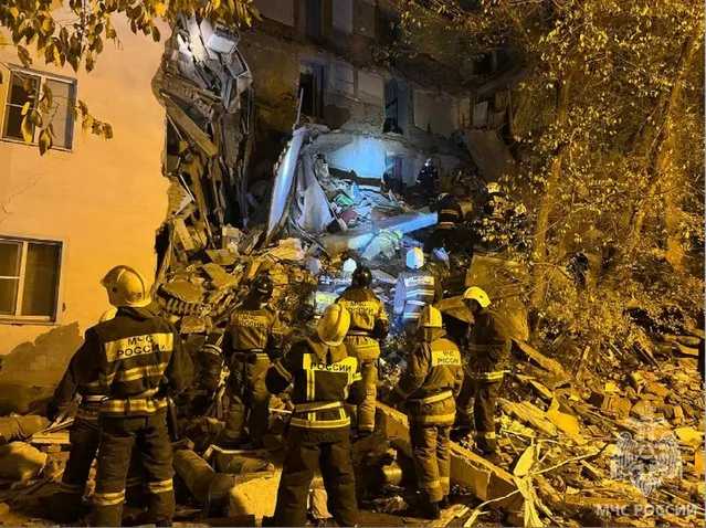 In this photo released by Russian Emergency Ministry Press Service on Thursday, November 16, 2023, Russian Emergency Ministry work at the side of a five-storey building partially collapsed in Astrakhan, Russia. Part of a residential building has collapsed in southern Russia, killing one woman and sparking a search and rescue operation, Russian state news agency Tass said. Before part of the building in the southern city of Astrakhan collapsed, the Ministry of Emergency Situations said it had received information about cracks appearing. (Photo by Russian Emergency Ministry Press Service via AP Photo)