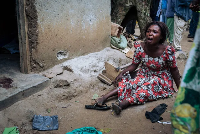 A woman mourns the death of her relatives killed in an attack in Masiani district in Beni last night by armed men gather at the scene on December 23, 2018. At least five people, including four civilians, were killed in an attack by Ugandan rebels over the border with DR Congo, an AFP reporter said on December 23, 2018, quoting witnesses. The attack by Uganda-based Allied Democratic Forces (ADF) targeted the locality of Masiani in Beni region and left at least one soldier dead as well as the civilians. (Photo by Alexis Huguet/AFP Photo)