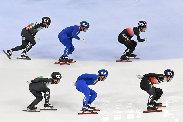 (L-R) Skaters from Bulgaria, Italy and South Korea compete during the semi-finals of the men's 5000m relay at the ISU World Cup Short Track Speed Skating event in Beijing on December 8, 2023. (Photo by Jade Gao/AFP Photo)