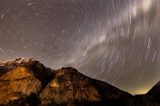 A long exposure shows star trails behind the Lopez Mountain during the annual Perseid meteor shower period near the town of Bariloche, at the Patagonia Region, Argentina on August 11, 2023. (Photo by Carlos Barria/Reuters)