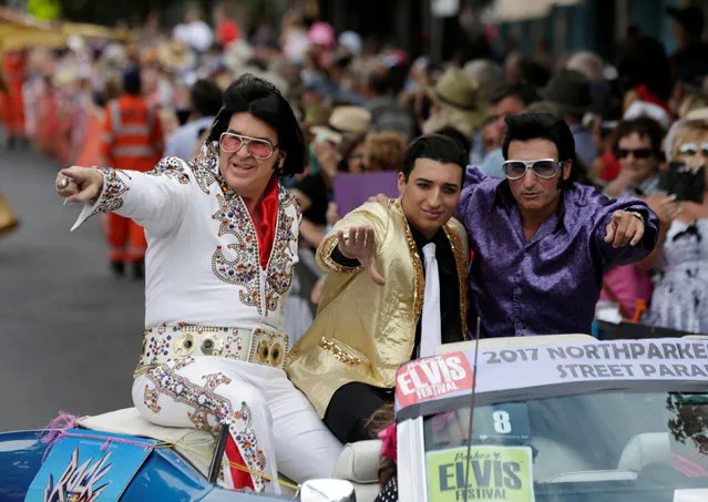 Men dressed as Elvis Presley ride in the back of a convertible during a street parade at the 25th annual Parkes Elvis Festival in the rural Australian town of Parkes, west of Sydney, January 14, 2017. (Photo by Jason Reed/Reuters)