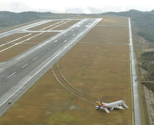 An aerial view shows an Asiana Airlines airplane which ran out of runway after landing at Hiroshima airport in Mihara, Hiroshima prefecture, western Japan, in this photo taken by Kyodo April 15, 2015. (Photo by Reuters/Kyodo)