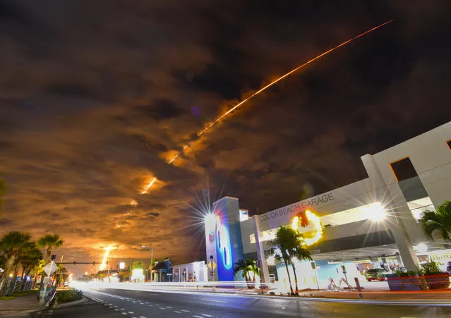 In a time exposure, the launch of a SpaceX Falcon 9 rocket from Launch Complex 40 at Cape Canaveral early Saturday, December 23, 2023, is seen from Cocoa Beach, Fla. The rocket carried Starlink satellites. (Photo by Malcolm Denemark/Florida Today via AP Photo)