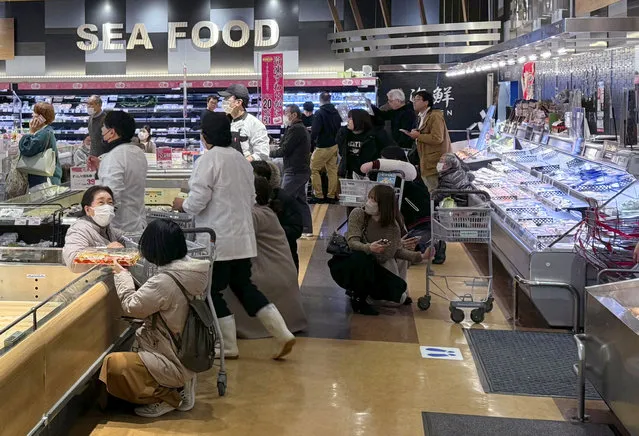 Shoppers crouch down as an earthquake hit the region at a supermarket in Toyama, Japan January 1, 2024, in this photo released by Kyodo. (Photo by Kyodo via Reuters)