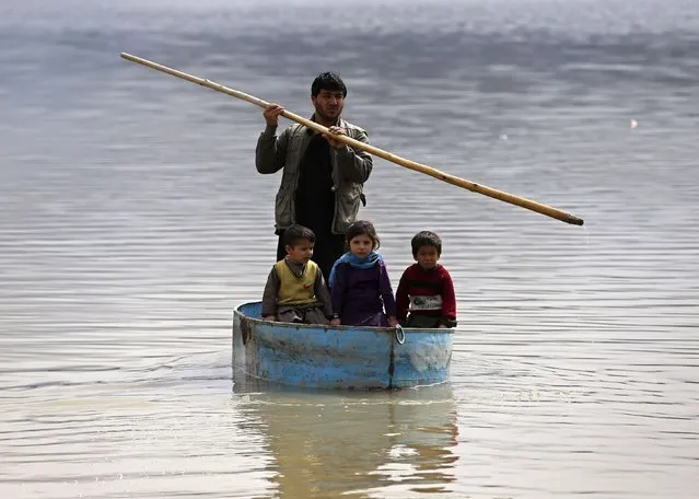 Afghan children sail on a homemade boat in a lake on the outskirts of Kabul, February 24, 2015. (Photo by Omar Sobhani/Reuters)