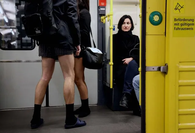 A subway passenger looks at participants of the No Pants Subway Ride in Berlin. (Photo by Adam Berry/Getty Images)