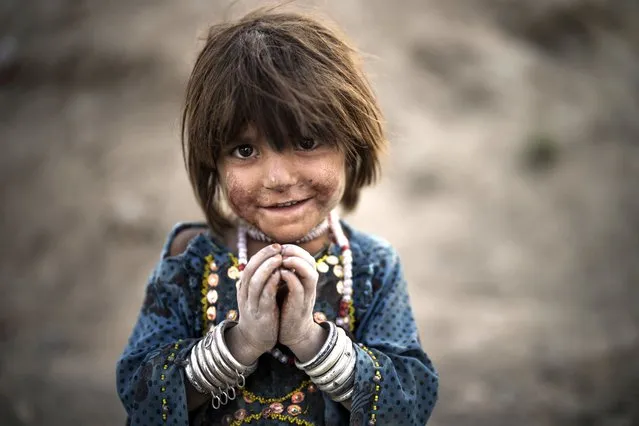 Laila poses for a photo as she plays at a poor neighborhood where hundreds of internally displaced people from the eastern part of the country have been living for years, in Kabul, Afghanistan, Monday, September 27, 2021. (Photo by Felipe Dana/AP Photo)