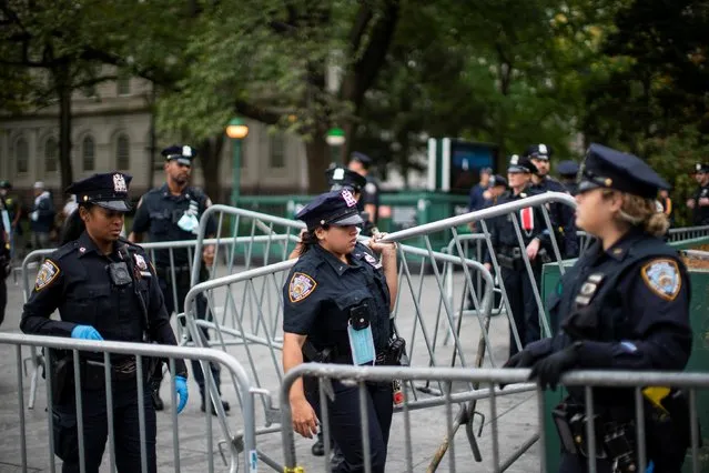 Police officers prepare barricades to control the arrival of people during a protest against COVID-19 vaccine mandate in New York City, New York, U.S., October 25, 2021. (Photo by Eduardo Munoz/Reuters)
