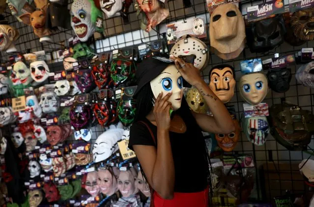 Jazmyne Richardson shops for Halloween items at the Halloween Megastore on October 13, 2021 in Miami, Florida. Halloween shoppers are being encouraged to shop for costumes and supplies early as stores struggle to maintain holiday stock due to disruptions in the supply chain. (Photo by Joe Raedle/Getty Images)