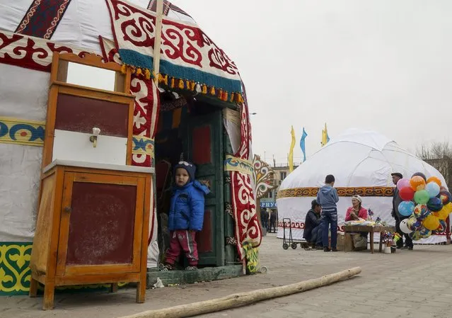 A boy standss at a doorway of a yurt, a traditional Kazakh tent, during Nauryz, an ancient holiday marking the spring equinox, celebrations in Kyzylorda, Kazakhstan, March 21, 2016. (Photo by Shamil Zhumatov/Reuters)