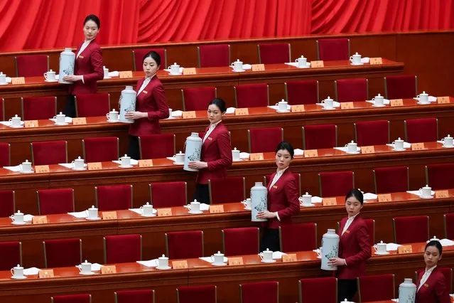 Attendents stand to serve tea on the day of the opening session of the Chinese People's Political Consultative Conference (CPPCC) at the Great Hall of the People in Beijing, China on March 4, 2024. (Photo by Florence Lo/Reuters)