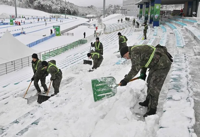 South Korean soldiers clear snow from the stands ahead of the single mixed relay 6km(W)+7.5km(M) biathlon during the Gangwon 2024 Winter Youth Olympic Games at Alpensia Biathlon Centre in Pyeongchang on January 21, 2024. (Photo by Jung Yeon-je/AFP Photo)