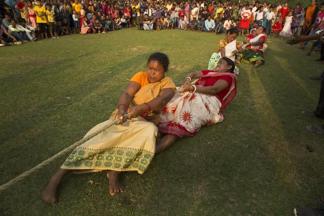 In this April 20, 2019, file photo, Indian women participate in a tug-of-war during Suwori Tribal festival in Boko, west of Gauhati, India. (Photo by Anupam Nath/AP Photo/File)