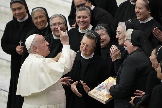 Pope Francis salutes a group of nuns at the end of his weekly general audience in the Paul VI Hall the Vatican, Wednesday, November 24, 2021. (Phoot by Andrew Medichini/AP Photo)